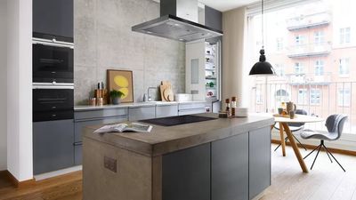 Cozinha moderna com fornos encastráveis, placa de indução e exaustor de ilha